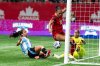Canada's Jade Rose (12) scores on Argentina goalkeeper Solana Pereyra (1) as Catalina Roggerone (4) watches during the first half of an international friendly soccer match in Vancouver, on Friday, April 4, 2025. THE CANADIAN PRESS/Ethan Cairns