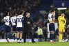 Tottenham's head coach Ange Postecoglou, center, and some of his players are seen after the end of the English Premier League soccer match between Chelsea and Tottenham Hotspur, at Stamford Bridge stadium, in London, Thursday, April 3, 2025. (AP Photo/Ian Walton)