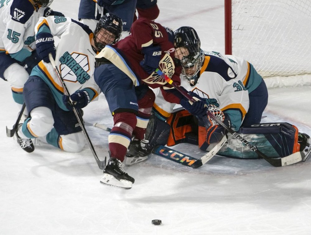 Montreal Victoire's Lina Ljungblom (25) gets in the face of New York Sirens goalie Corinne Schroeder (30) as she tries to score during second period PWHL hockey action in Laval, Que., Tuesday, April 1, 2025. THE CANADIAN PRESS/Peter McCabe