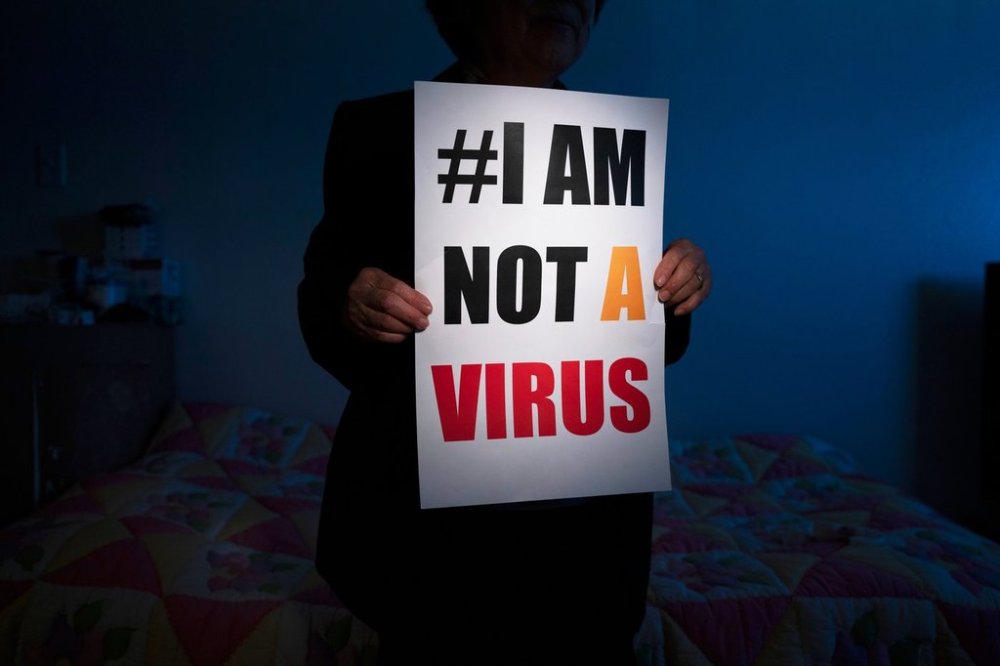 FILE - Jen Ho Lee, a 76-year-old South Korean immigrant, poses in her apartment with a sign from a recent rally against anti-Asian hate crimes she attended Wednesday, March 31, 2021, in Los Angeles. (AP Photo/Jae C. Hong, File)