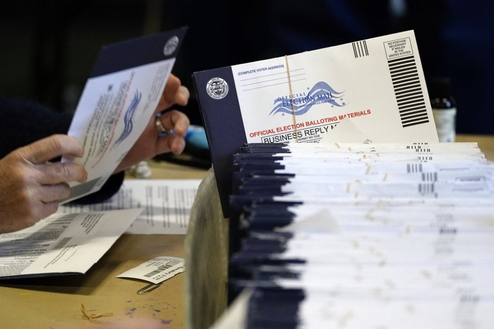 FILE - Chester County, Pa., election workers process mail-in and absentee ballots at West Chester University in West Chester, Pa., Nov. 4, 2020. (AP Photo/Matt Slocum, File)