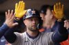 Houston Astros' Christian Walker (8) celebrates in the dugout after hitting a solo home run during the second inning of a baseball game against the Minnesota Twins, Thursday, April 3, 2025, in Minneapolis. (AP Photo/Abbie Parr)
