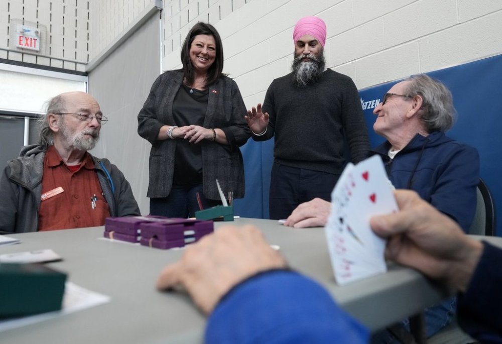 NDP Leader Jagmeet Singh, second left, and NDP candidate Monique Taylor, second right, visits with people while they play bridge at a recreation centre during a federal election campaign stop in Hamilton, Ont., Wednesday, March 26, 2025. THE CANADIAN PRESS/Nathan Denette