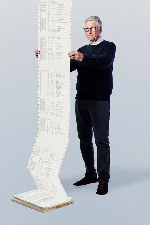 This 1975 photo provided by Gates Ventures shows Microsoft founder Bill Gates holding a printout of the computer coding that launched the software maker. (Ian Allen/Gates Ventures via AP)