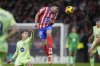 Atletico Madrid's Julian Alvarez, top, heads the ball past Barcelona's Marc Casado during a La Liga soccer match between Atletico Madrid and FC Barcelona at the Metropolitano stadium in Madrid, Sunday, March 16, 2025. (AP Photo/Bernat Armangue)