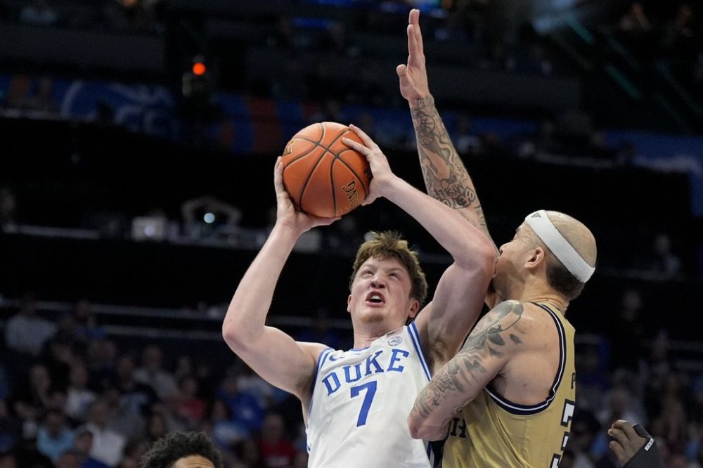 Duke guard Kon Knueppel shoots over Georgia Tech forward Duncan Powell during the second half of an NCAA college basketball game in the quarterfinals of the Atlantic Coast Conference tournament, Thursday, March 13, 2025, in Charlotte, N.C. (AP Photo/Chris Carlson)