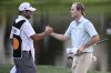 Russell Henley, right, is congratulated by his caddie on the 18th green after winning the Arnold Palmer Invitational at Bay Hill golf tournament, Sunday, March 9, 2025, in Orlando, Fla. (AP Photo/Phelan M. Ebenhack)
