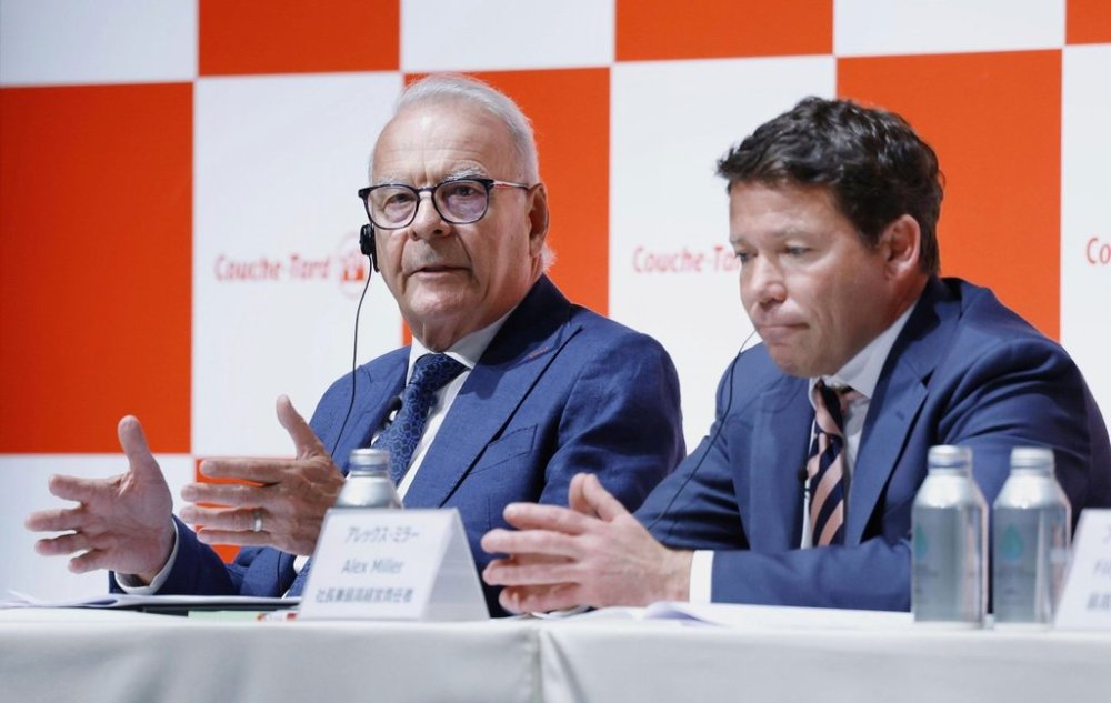 Alimentation Couche-Tard Inc. CEO Alex Miller says his company remains committed to acquiring the Japanese operator of the 7-Eleven chain despite recent pushback. Miller, right, and Alain Bouchard, chairman of Alimentation Couche-Tard, left, attend a press conference in Tokyo, Japan, Thursday, March 13, 2025. (Kyodo News via AP)