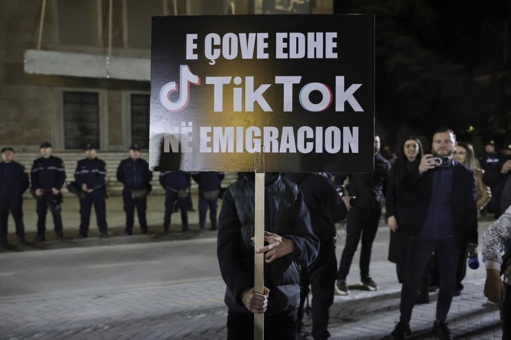 A protester holds a banner during a rally against the leftwing Socialist Party government's decision to shut down TikTok, in Tirana, Albania, Saturday, Mar. 15, 2025. The banner reads: