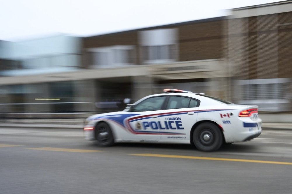 A police car drives by London Police headquarters in London, Ont., Monday, Jan. 29, 2024. THE CANADIAN PRESS/Geoff Robins