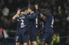 PSG's players celebrate after PSG's Nuno Mendes scored his side's second goal during the French League One soccer match between Paris Saint Germain and Marseille at Parc des Princes stadium in Paris, Sunday, March 16, 2025. (AP Photo/Christophe Ena)