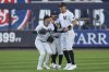 New York Yankees' outfielders Cody Bellinger, left, Trent Grisham, center, and Aaron Judge celebrate after winning a baseball game against the Milwaukee Brewers at Yankee Stadium, Thursday, March 27, 2025, in New York. (AP Photo/Seth Wenig)