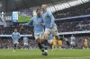 Manchester City's Erling Haaland, right, celebrates with his teammate Omar Marmoush after scoring his side's opening goal during the English Premier League soccer match between Manchester City and Brighton and Hove Albion at Etihad stadium in Manchester, England, Saturday, March 15, 2025. (AP Photo/Ian Hodgson)
