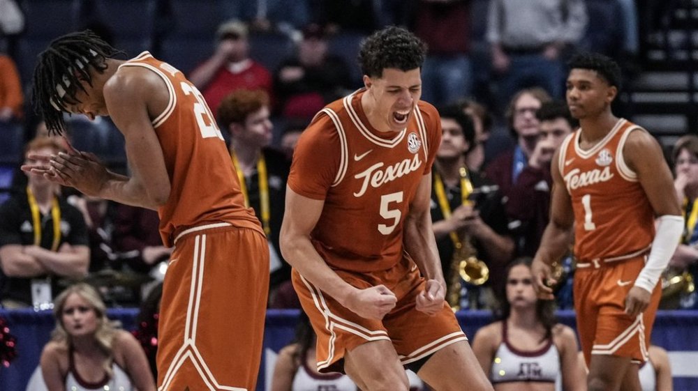 Texas players celebrate victory over Texas A&M during the second overtime in an NCAA college basketball game in the second round of the Southeastern Conference tournament, Thursday, March 13, 2025, in Nashville, Tenn. (AP Photo/George Walker IV)