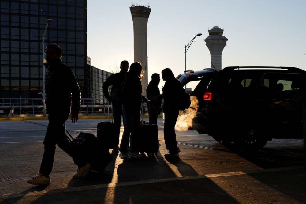 FILE - Travelers walk at O'Hare International Airport in Chicago, on Nov. 26, 2024. (AP Photo/Nam Y. Huh)
