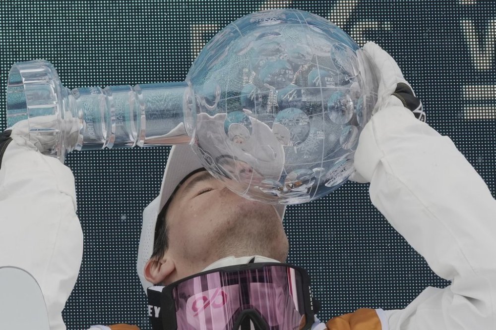 Canada's Mikael Kingsbury kisses the Crystal Globe trophy after winning the men's freestyle skiing moguls overall leader title at the World Cup Finals and Olympics Milano-Cortina 2026 test event in Livigno, Italy, Wednesday, March 12, 2025. (AP Photo/Antonio Calanni)