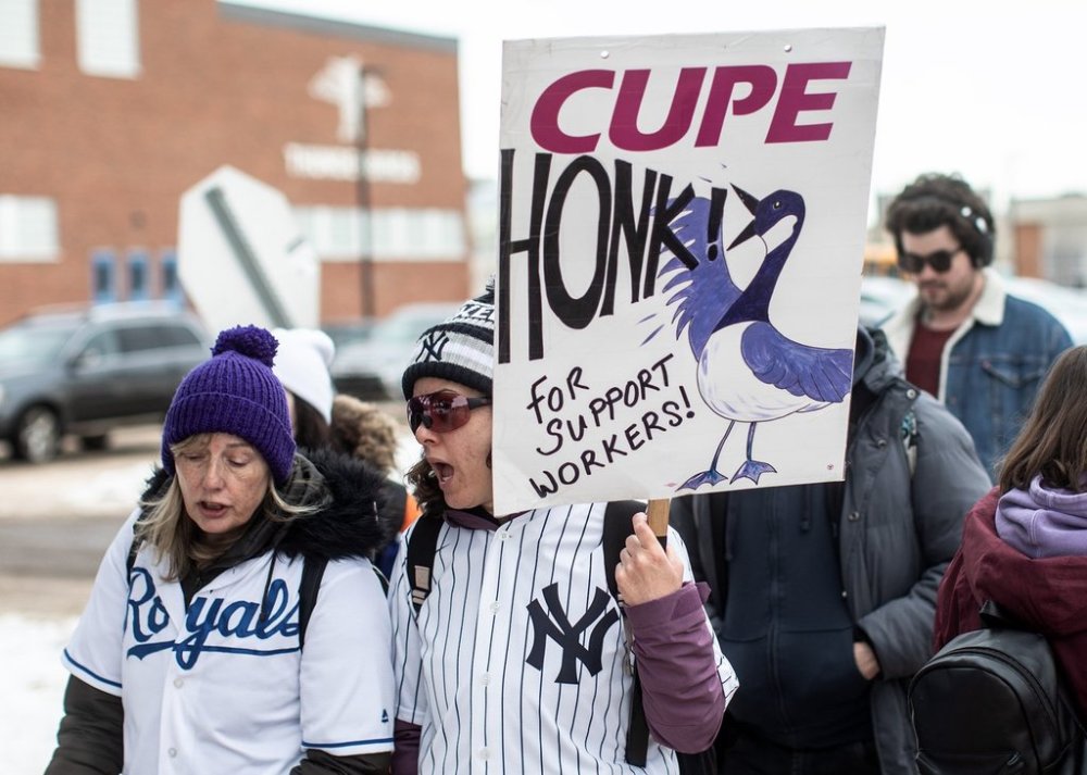 CUPE members and supporters picket outside of a school in Edmonton on Friday February 21, 2025. THE CANADIAN PRESS/Jason Franson
