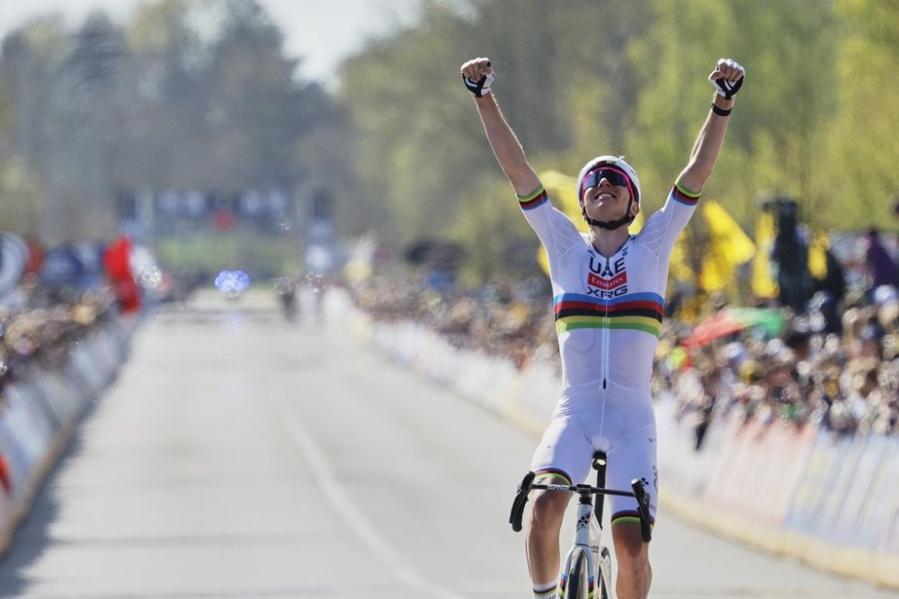 Slovenia's Tadej Pogacar, of the UAE Team Emirates XRG, crosses the finish line to win the Tour of Flanders in Oudenaarde, Belgium on Sunday, April 6, 2025. (AP Photo/Geert Vanden Wijngaert)