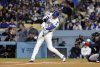Los Angeles Dodgers' Shohei Ohtani hits a ground out against the Atlanta Braves during the first inning of a baseball game Tuesday, April 1, 2025, in, Los Angeles. (AP Photo/Kevork Djansezian)
