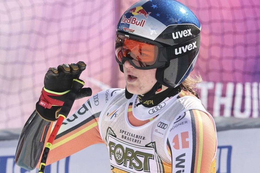 Germany's Emma Aicher reacts after completing an alpine ski, women's World Cup super G race, in La Thuile, Italy, Thursday, March 13, 2025. (AP Photo/Marco Trovati)