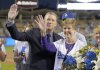 FILE - Former Los Angeles Dodgers pitcher Orel Hershiser waves with organist Nancy Bea Hefley during a ceremony prior to a baseball game between the Dodgers and the San Diego Padres, on Oct. 2, 2015, in Los Angeles. (AP Photo/Mark J. Terrill, File)