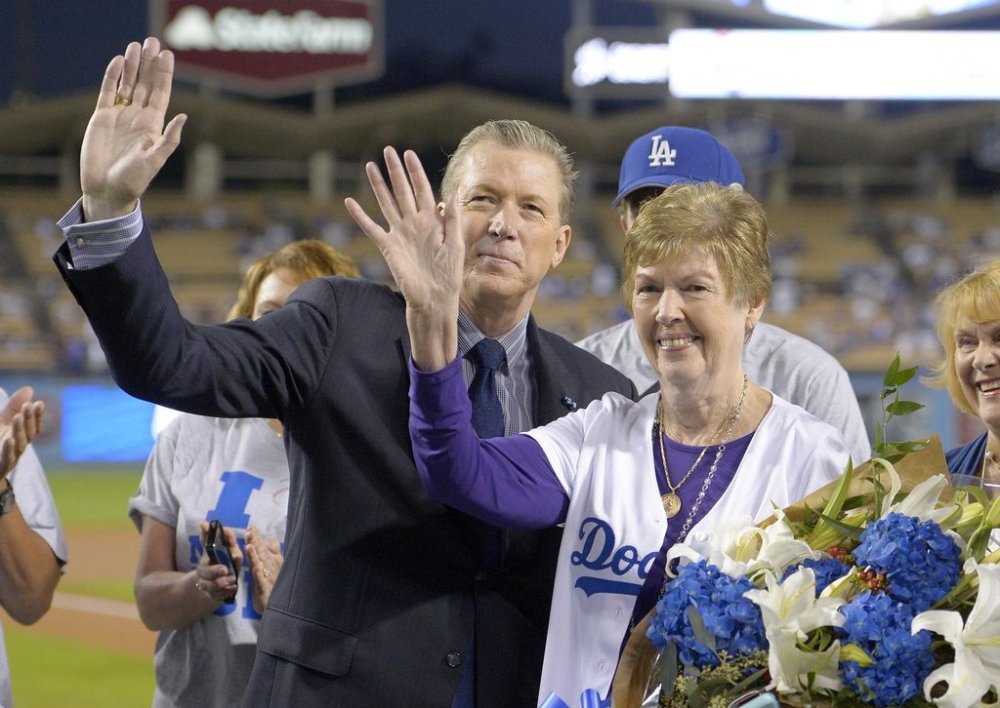 FILE - Former Los Angeles Dodgers pitcher Orel Hershiser waves with organist Nancy Bea Hefley during a ceremony prior to a baseball game between the Dodgers and the San Diego Padres, on Oct. 2, 2015, in Los Angeles. (AP Photo/Mark J. Terrill, File)