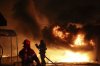 Firefighters extinguish a fire at a factory building that has been engulfed in a wildfire in Uiseong, South Korea, Saturday, March 22, 2025. (Yoon Gwan-shick/Yonhap via AP)