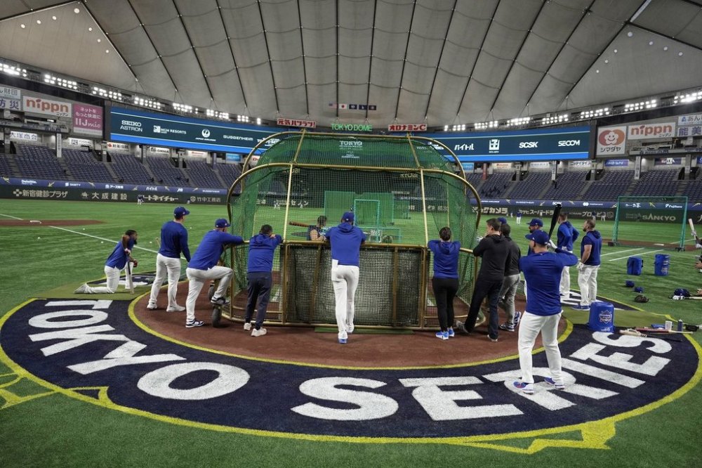 Players of Los Angeles Dodgers warm up during a training session in Tokyo, Friday, March 14, 2025, ahead of the Dodgers to play their MLB opening games against the Chicago Cubs at the Tokyo Dome next week. (AP Photo/Eugene Hoshiko)