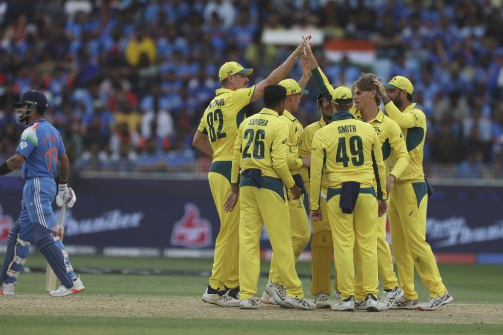 Australia's Cooper Connolly, second right, celebrates the dismissal of India's captain Rohit Sharma, right, during the ICC Champions Trophy semifinal cricket match between India and Australia at Dubai International Cricket Stadium in Dubai, United Arab Emirates, Tuesday, March 4, 2025. (AP Photo/Christopher Pike)