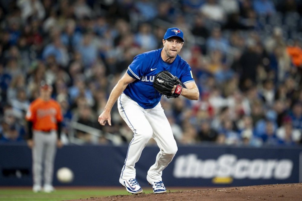 Toronto Blue Jays pitcher Max Scherzer (31) watches the ball on a ground out by Baltimore Orioles' Jackson Holliday (not shown) during second inning MLB baseball action, in Toronto on Saturday, March 29, 2025. THE CANADIAN PRESS/Christopher Katsarov