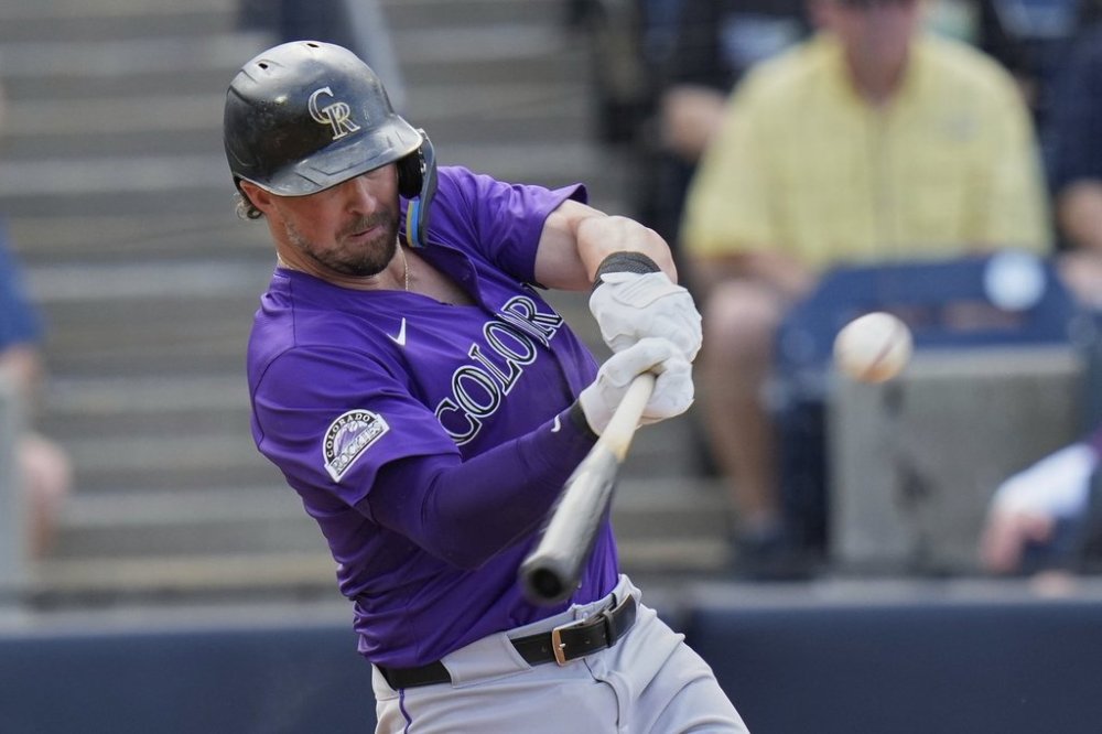 Colorado Rockies' Kyle Farmer lines an RBI single off Tampa Bay Rays pitcher Garrett Cleavinger during the seventh inning of a baseball game Saturday, March 29, 2025, in Tampa, Fla. (AP Photo/Chris O'Meara)