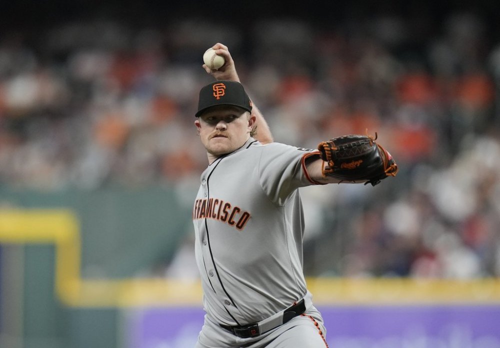 San Francisco Giants starting pitcher Logan Webb (62) pitches to Houston Astros' Jose Altuve during the first inning of a baseball game Tuesday, April 1, 2025, in Houston. (AP Photo/Karen Warren)