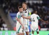 Newcastle United's Harvey Barnes celebrates scoring their side's third goal of the game with teammate Dan Burn during the English Premier League soccer match between Leicester City and Newcastle United at the King Power Stadium, Leicester, England, Monday, April 7, 2025. (Mike Egerton/PA via AP)