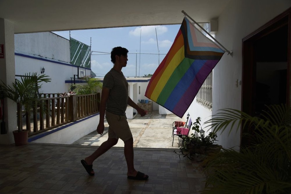 A person walks past a pride flag at Casa Frida, a shelter that supports LGBTQ+ migrants, in Tapachula, Chiapas state, Mexico, Wednesday, March 12, 2025. (AP Photo/Moises Castillo)
