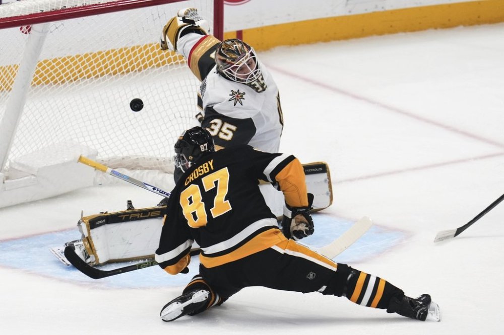 Pittsburgh Penguins' Sidney Crosby (87) gets a shot behind Vegas Golden Knights goaltender Ilya Samsonov (35) for a goal during the first period of an NHL hockey game in Pittsburgh, Tuesday, March 11, 2025. (AP Photo/Gene J. Puskar)