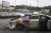 FILE - A member of the Seattle Fire Department inspects a burned Tesla Cybertruck at a Tesla lot in Seattle, Monday, March 10, 2025. (AP Photo/Lindsey Wasson, File)