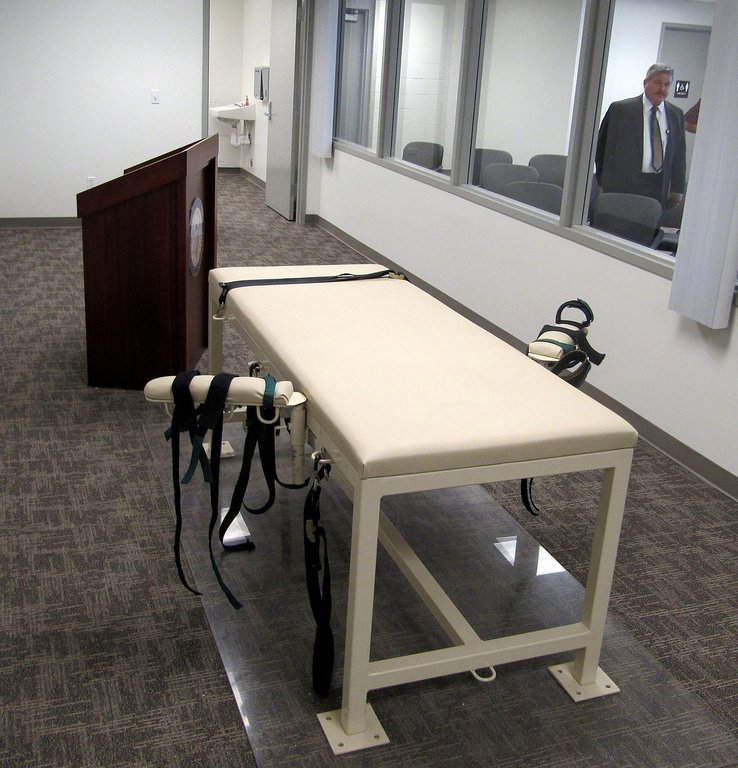 FILE - The execution chamber at the Idaho Maximum Security Institution is shown as Security Institution Warden Randy Blades look on in Boise, Idaho, Oct. 20, 2011. (AP Photo/Jessie L. Bonner, File)