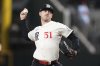 Texas Rangers starting pitcher Tyler Mahle throws to the Tampa Bay Rays in the first inning of a baseball game in Arlington, Texas, Friday, April 4, 2025. (AP Photo/Tony Gutierrez)