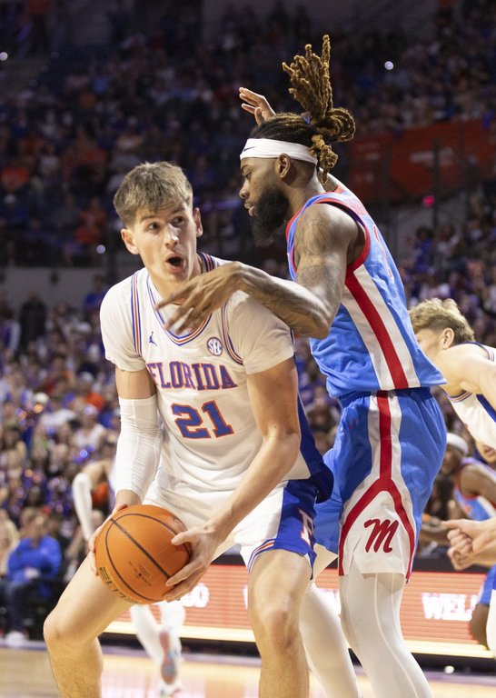Florida forward Alex Condon (21) takes the rebound from Mississippi forward Mikeal Brown-Jones, right, during the first half of an NCAA college basketball game Saturday, March 8, 2025, in Gainesville, Fla. (AP Photo/Alan Youngblood)