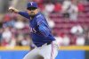Texas Rangers' Nathan Eovaldi (17) delivers a pitch in the second inning of a baseball game against the Cincinnati Reds, Tuesday, April 1, 2025, in Cincinnati. (AP Photo/Kareem Elgazzar)