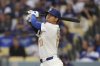 Los Angeles Dodgers' Shohei Ohtani hits a solo home run during the seventh inning of a home-opening baseball game against the Detroit Tigers, Thursday, March 27, 2025, in Los Angeles. (AP Photo/Mark J. Terrill)