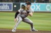 FILE - San Francisco Giants first baseman Mark Canha fields a ground ball hit by Arizona Diamondbacks' Jose Herrera before throwing to first base for an out during the third inning of a baseball game, Sept. 23, 2024, in Phoenix. (AP Photo/Ross D. Franklin, File)