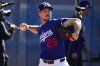 FILE - Los Angeles Dodgers pitcher Michael Grove (29) throws during spring training baseball practice, Feb. 15, 2025, in Phoenix. (AP Photo/Ashley Landis, File)