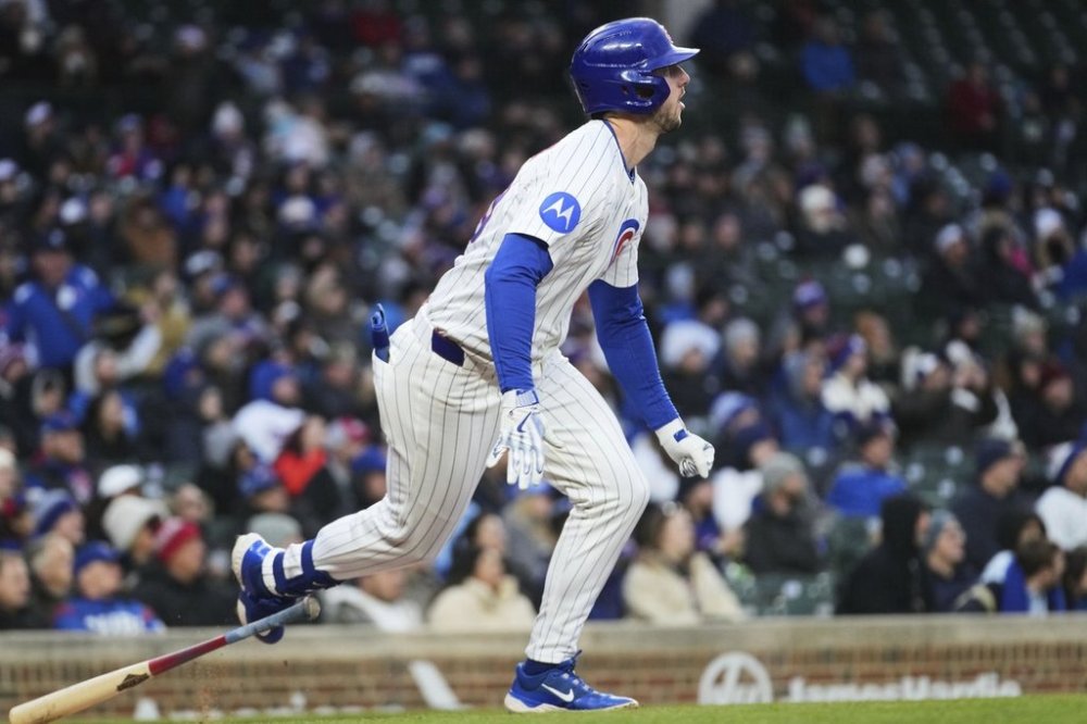 Chicago Cubs' Kyle Tucker watches his single as he runs to first base during the first inning of a baseball game against the Texas Rangers in Chicago, Monday, April 7, 2025. (AP Photo/Nam Y. Huh)