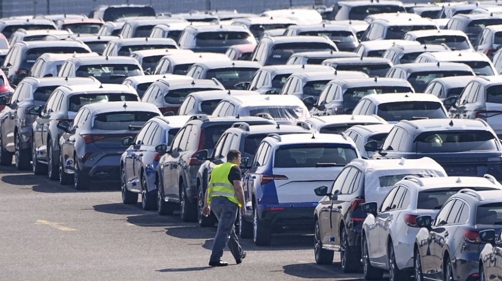 New German cars are stored at a logistic center in Duisburg, Germany, Thursday, March 27, 2025. (AP Photo/Martin Meissner)