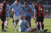 Manchester City's Erling Haaland, front, reacts after sustaining an injury during the English FA Cup quarterfinal soccer match between Bournemouth and Manchester City at the Vitality stadium in Bournemouth, England, Sunday, March 30, 2025. (AP Photo/Ian Walton)