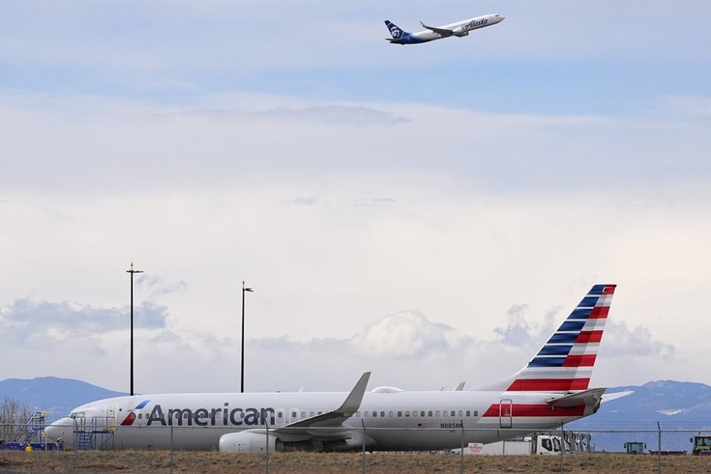 An American Airlines jetliner that caught fire after landing Thursday at Denver International Airport sits near a hangar at the airport Friday, March 14, 2025, in Denver. (AP Photo/David Zalubowski)