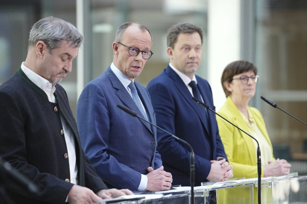 From left, Markus Soeder, (CSU), Minister President of Bavaria and CSU Chairman, Friedrich Merz, Union candidate for Chancellor and CDU Federal Chairman, Lars Klingbeil, SPD Parliamentary Group and Federal Chairman, and Saskia Esken, SPD Federal Chairman, take part in a press conference following the exploratory talks between the CDU/CSU and SPD in the Bundestag in Berlin, Saturday, March 8, 2025. (Kay Nietfeld/dpa via AP)
