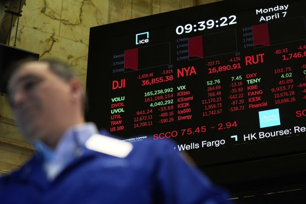 Electronic displays shows financial information on the floor at the New York Stock Exchange in New York, Monday, April 7, 2025. (AP Photo/Seth Wenig)