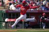 Los Angeles Angels' Jo Adell scores on a base hit by Taylor Ward during the third inning of a spring training baseball game against the Cleveland Guardians, Wednesday, March 19, 2025, in Tempe, Ariz. (AP Photo/Matt York)